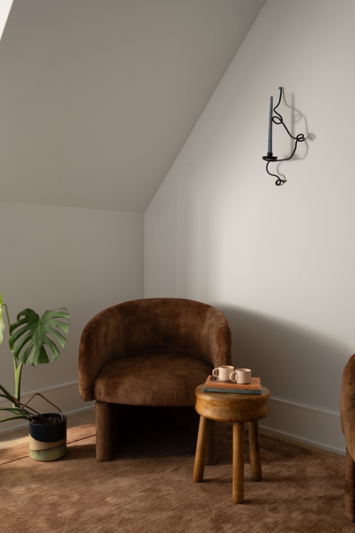 Reading corner with velvet chair under the eaves